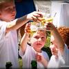 Children toasting glasses of sparkling cider.
