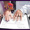 wedding photo of marriage certificate and wedding rings.